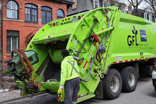 Toronto garbage truck loading compostable food waste bin