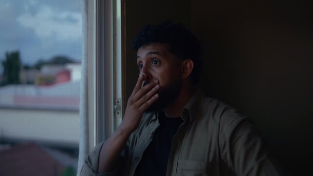 Sad woman looking through a window