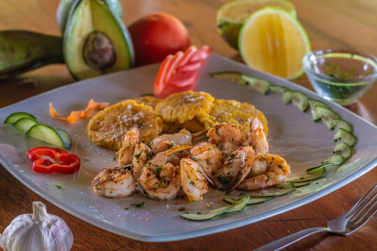 Grilled shrimp patacones and fresh peruvian seafood dish