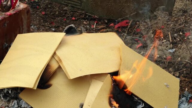 Chinese Qingming Festival activities involving ancestor worship and burning of joss paper.