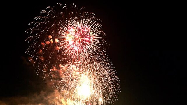 夜の遊園地に上がる大輪の打ち上げ花火
「遊園地の向こう側に上がる花火を遠くから眺めているような、どこか懐かしさを感じさせる映像です。旅のVlogや、夏の終わりの思い出を演出するインサートカットに最適です。」
荒尾市(グリーンランド)
Large, spectacular fireworks light up the night sky above an amusement park.