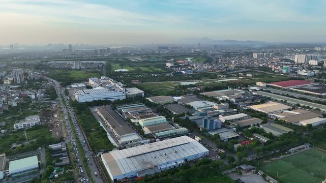 Aerial daytime view of an industrial zone in Long Bien district, Hanoi, featuring factories, warehouses, road network, and surrounding residential and green areas.