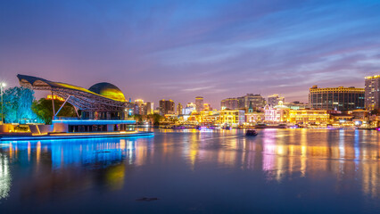 Fototapeta premium Night View of Modern Urban Waterfront with Illuminated Buildings