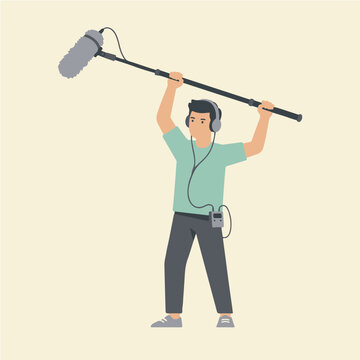 Sound Recordist Holding Boom Microphone and Wearing Headphones.