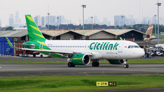 Close up view of Citilink Indonesia airplane fuselage and green engine on taxiway on April 14, 2026 in Soekarno-Hatta Interational Airport, Jakarta, Indonesia.