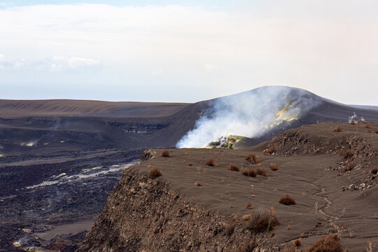 Steaming fumarole with yellow sulfur deposits on the edge of a volcanic crater in Hawaii Volcanoes National Park Hawaii