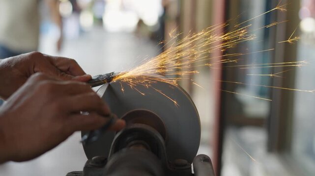 Craftsman sharpening a blade on the street