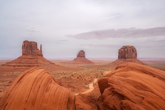 Signature view landscape of Monument Valley, West Mitten Butte, East Mitten Butte, and Merrick Butte in northeastern Arizona. LAndmark, tourist attraction