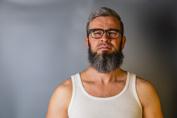 Bearded man profile and front view isolated portrait series Man with glasses and beard stands against a gray background © mykhailo