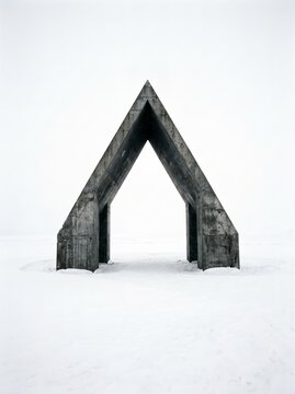 Concrete Gabled Arch in Snow. Minimal brutalist monument