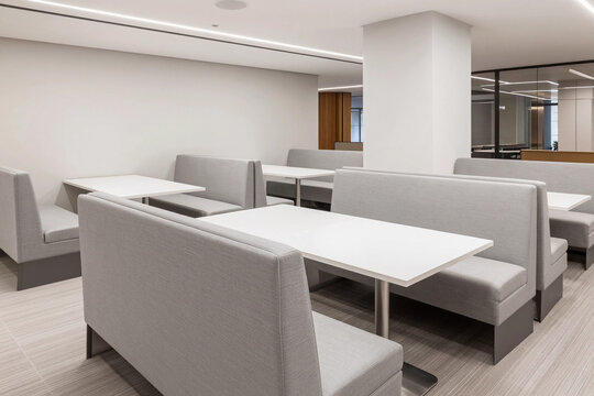 Modern, minimalist dining area with sleek booths.