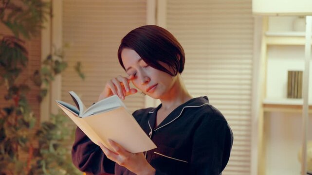 パジャマで読書をする女性