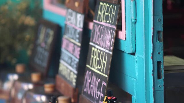 Fresh signs at a colorful food stall in a market