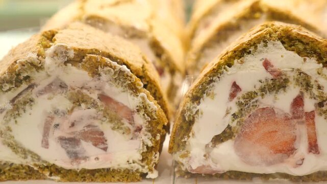 Freshly made cake roll with strawberries and cream