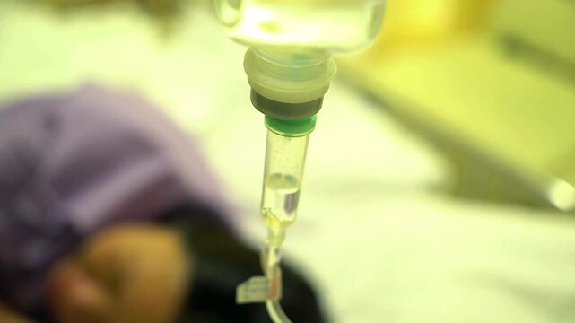 Asian elderly patient recovery after surgery in hospital icu and emergency or recovery Nurse sets directly into vein saline bottle iv drip background