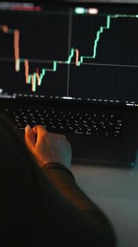 Close up of trader monitoring financial charts on laptop, analyzing market trends and price movements in digital trading environment, investment concept.