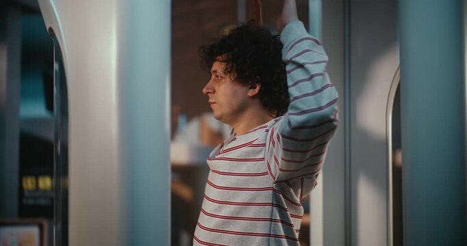 Male Traveler Stands Inside Airport Security Scanner With Arms Raised, Following Standard Screening Instructions Before Departure. Busy Terminal Operations and Strict Aviation Safety Procedures.