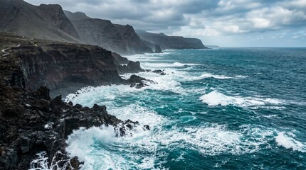Fototapeta premium Dramatic Seascape with Waves Crashing Against Dark Volcanic Rocks and Turquoise Water