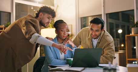 Group, pointing and teamwork with laptop in business, working late or reporter with article deadline. Newsroom, online and people with smile for assignment, reading and creative with tech at night © peopleimages.com