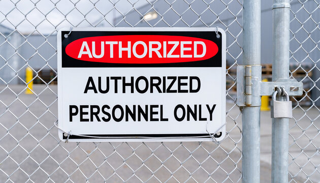 Authorized Personnel Sign: A close-up shot of a warning sign that restricts access to Authorized Personnel Only hangs on a chain-link fence, the lock gleaming with security.