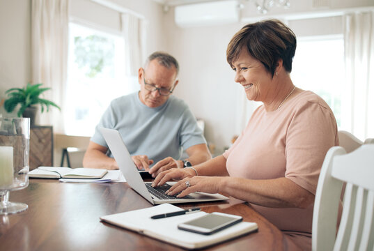 Laptop, budget and smile with couple in home for mortgage payment, research and savings. Financial review, insurance paperwork and online bank statement with mature man and woman in house for bills