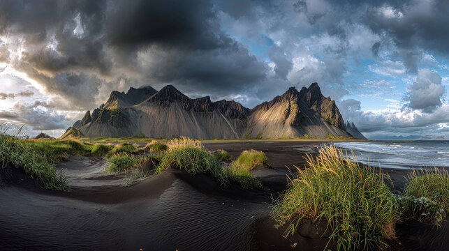 Black sand dunes on the Stokksnes headland on southeastern Icelandic coast with Vestrahorn (Batman Mountain). Picturesque summer panorama of Iceland, Europe. Instagram filter toned.