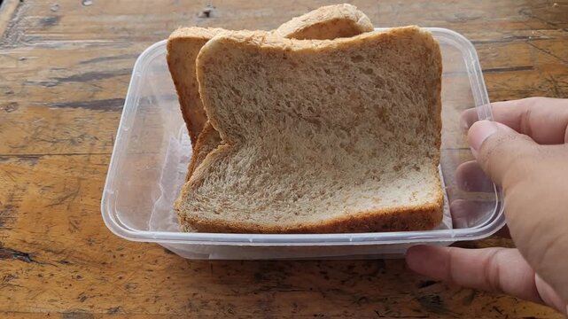 Preparing lunchb on the lunchbox with bread on
