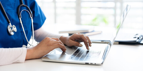  professional  doctor using laptop computer in hospital office watching medical webinar training,...