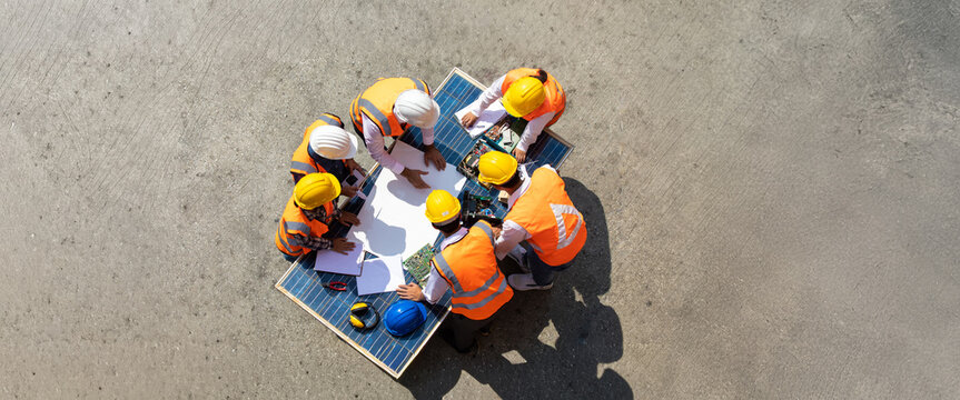 Ethnic diversity worker people, Success teamwork. Group of professional engineering people wearing hardhat safety helmet meeting with solar photovoltaic panels discussion in new project