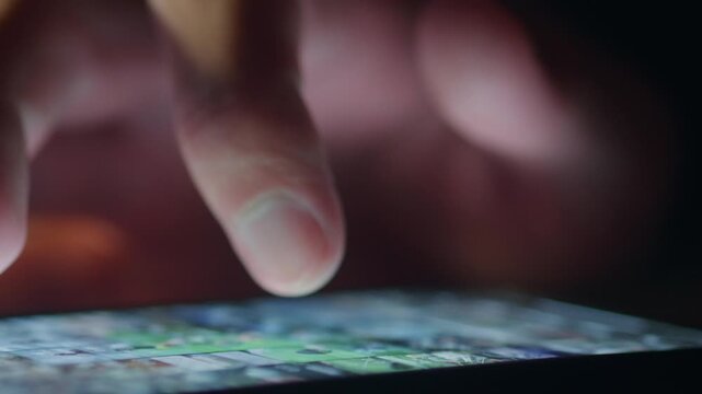 Close up male finger scrolling smartphone news feed on glowing screen in dark. News scrolling reflects digital news consumption fast information access mobile journalism, constant online news updates.