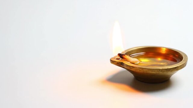White background with one diya and soft warm shadow, clean devotional style,