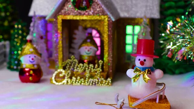 A beautiful house with two snowmen on the porch and next to it and a snowman on a sled in front