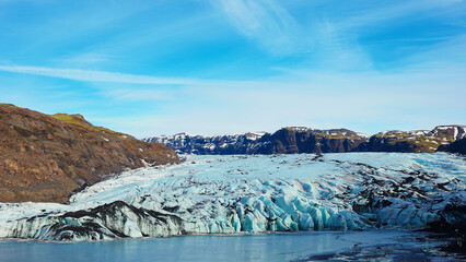 Vatnajokull glacier covered in frost in iceland, spectacular massive icebergs colored with white and blue. Frozen cold ice cap in icelandic winter landscape and arctic snowy mountains. © DC Studio