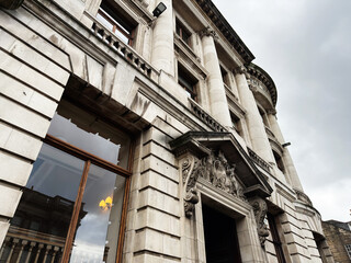 Naklejka premium Historic stone building facade with neoclassical columns and carved ornamentation in Edinburgh, Scotland, UK