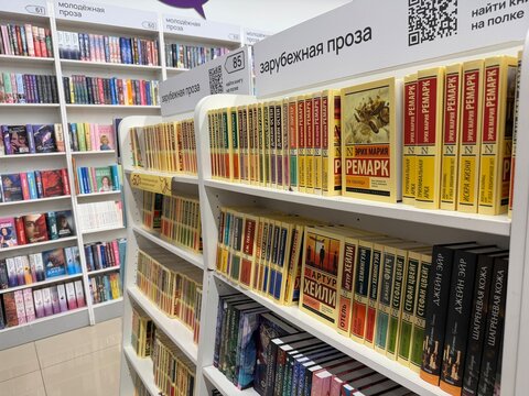 Moscow, Russia - April 14, 2026: Bookshelves filled with foreign literature in a bookstore featuring titles by Erich Maria Remarque and Arthur Hailey
