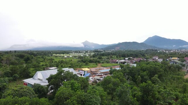 Drone aerial view tropical village with mountains and forest landscape