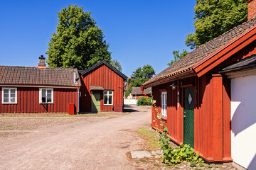 Cobblestone square with idyllic red cottages on a sunny summer day © Lars Johansson