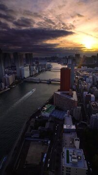 隅田川と勝どき橋とベイエリア方向のビル群と船と夕日