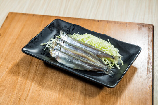 Chilled small whole fish on cabbage bed