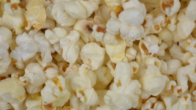 Extreme close-up view of fresh popcorn rotating slowly showcasing its fluffy and varied texture as a detailed macro shot