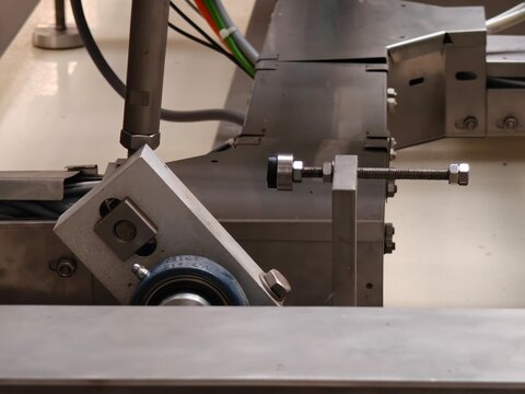 Adjusted screw stop inside a machine.