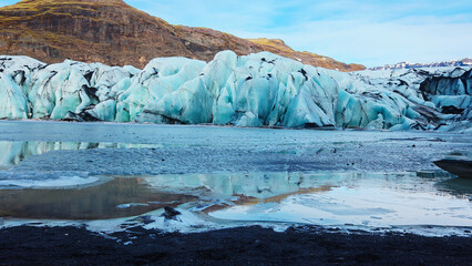 Large vatnajokull nordic ice cap next to frozen lake in icelandic landscape, majestic diamond shaped glacier in freezing cold winter scenery. Natural arctic icebergs and ice blocks. Handheld shot. © DC Studio