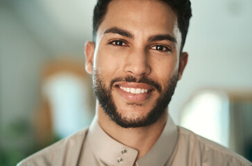 Fototapeta premium Confident, portrait and Muslim man with smile in home, relax and religious with traditional clothes. Culture, space and person with thobe for Islamic faith, peace and happiness on break in house