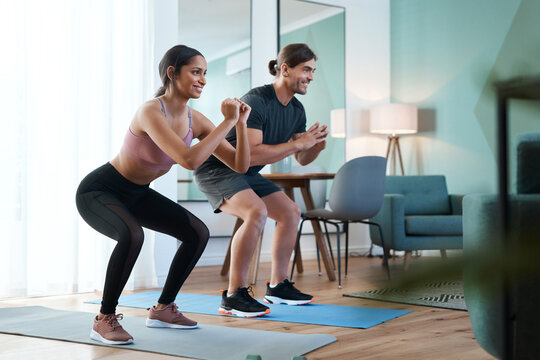 Smile, couple and squat for fitness at house with exercise, strength training and bonding together. Happy, people and balance for strong quads, muscle growth and endurance challenge with home workout