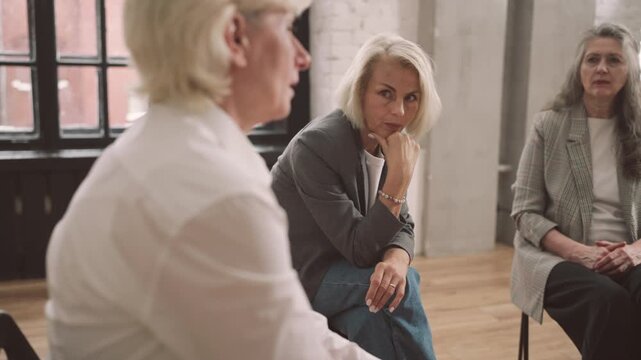 Senior ladies discussing life problems in psychological support group, rehab. Violence victims talking about troubles and relationships, divorced women or alcoholics anonymous, mental health clinic