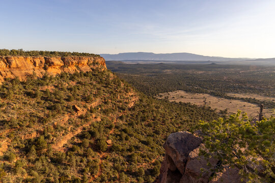 High above desert floor on sheer rocky cliff mesa