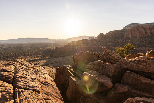 Sun flare over rocky rugged desert landscape