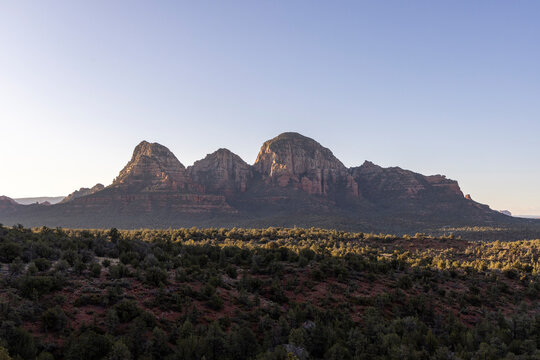 Distant rock formations in forested Sedona wilderness