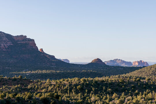 Open rugged forested desert landscape and distant formations
