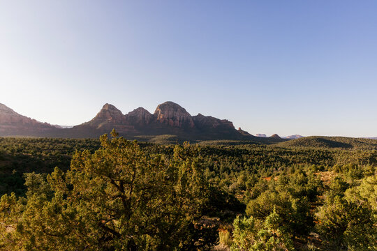 Distant rock formation rising from wooded rolling landscape